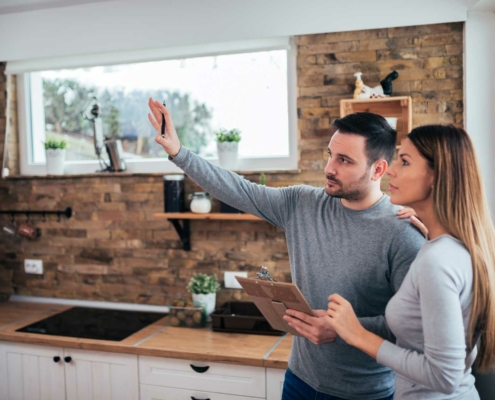 Inspector in kitchen with woman